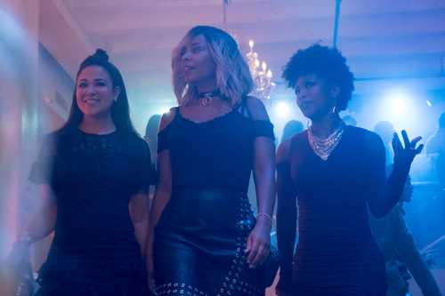 Three women walking confidently into a nightclub.