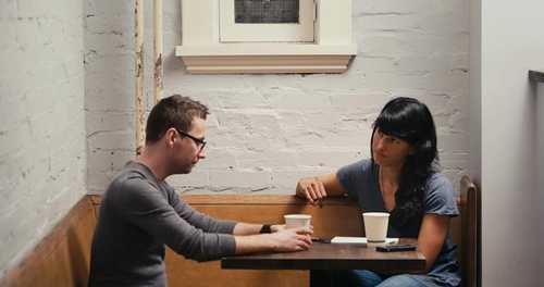 A couple having a heavy conversation at a restaurant table.