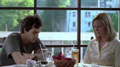 A couple having a very difficult conversation at a restaurant table.